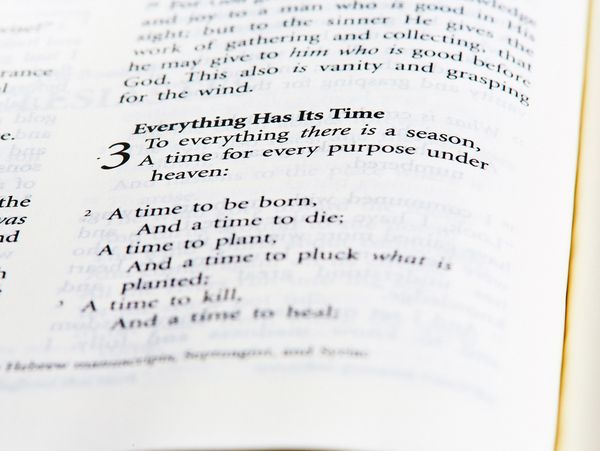 Open Bible showing Ecclesiastes 3:1-3 about life's seasons and times.