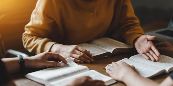 Personas estudiando con libros abiertos.