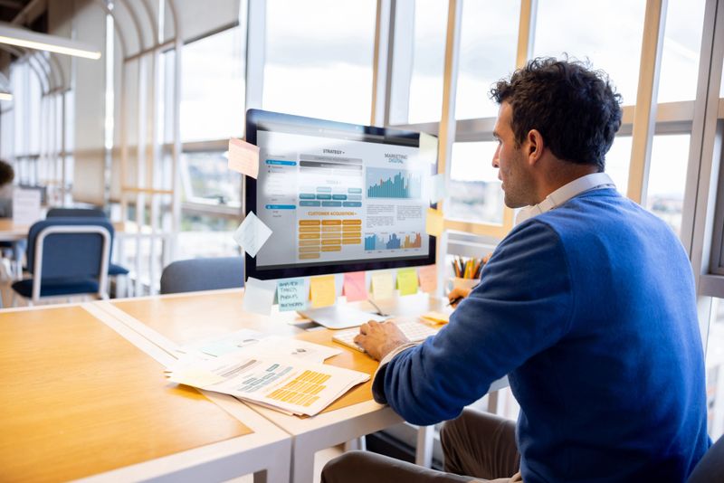 Latin American entrepreneur working on a financial report for his business at a coworking office