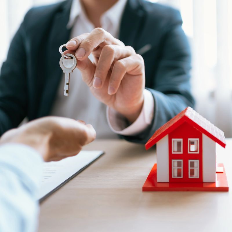 Real estate agent meeting customer with insurance policy about house contract.