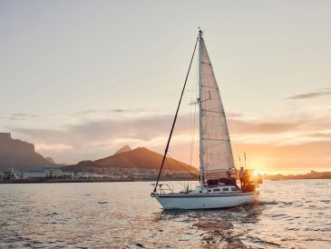 Sailboat on calm water at sunset.