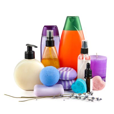 A collection of colorful bath and spa products arranged with lavender sprigs.