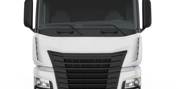 Front view of a modern white semi-truck with black grille and headlights.