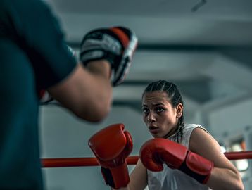Woman boxing in a gym, focused and ready.