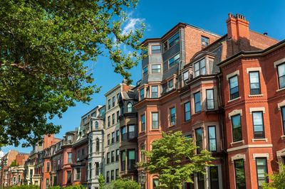 Brick homes on a tree-lined street, like the rentals Incline manages in Regent Square