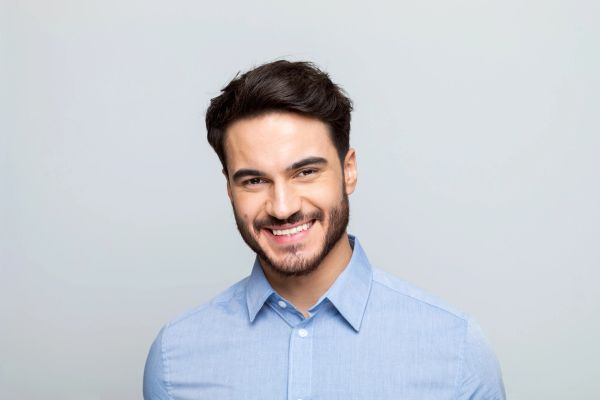 Smiling man in a blue shirt.