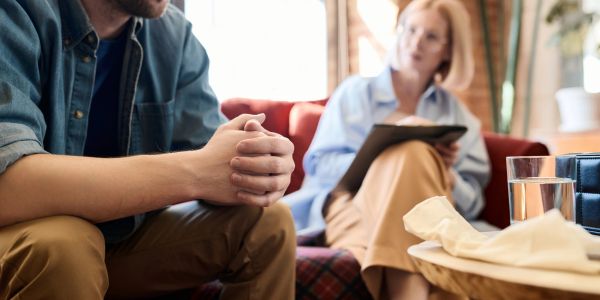 Person discussing with therapist in a counseling session.