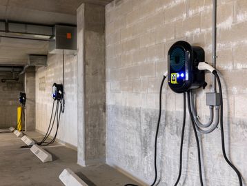 Electric vehicle charging stations in a parking garage.