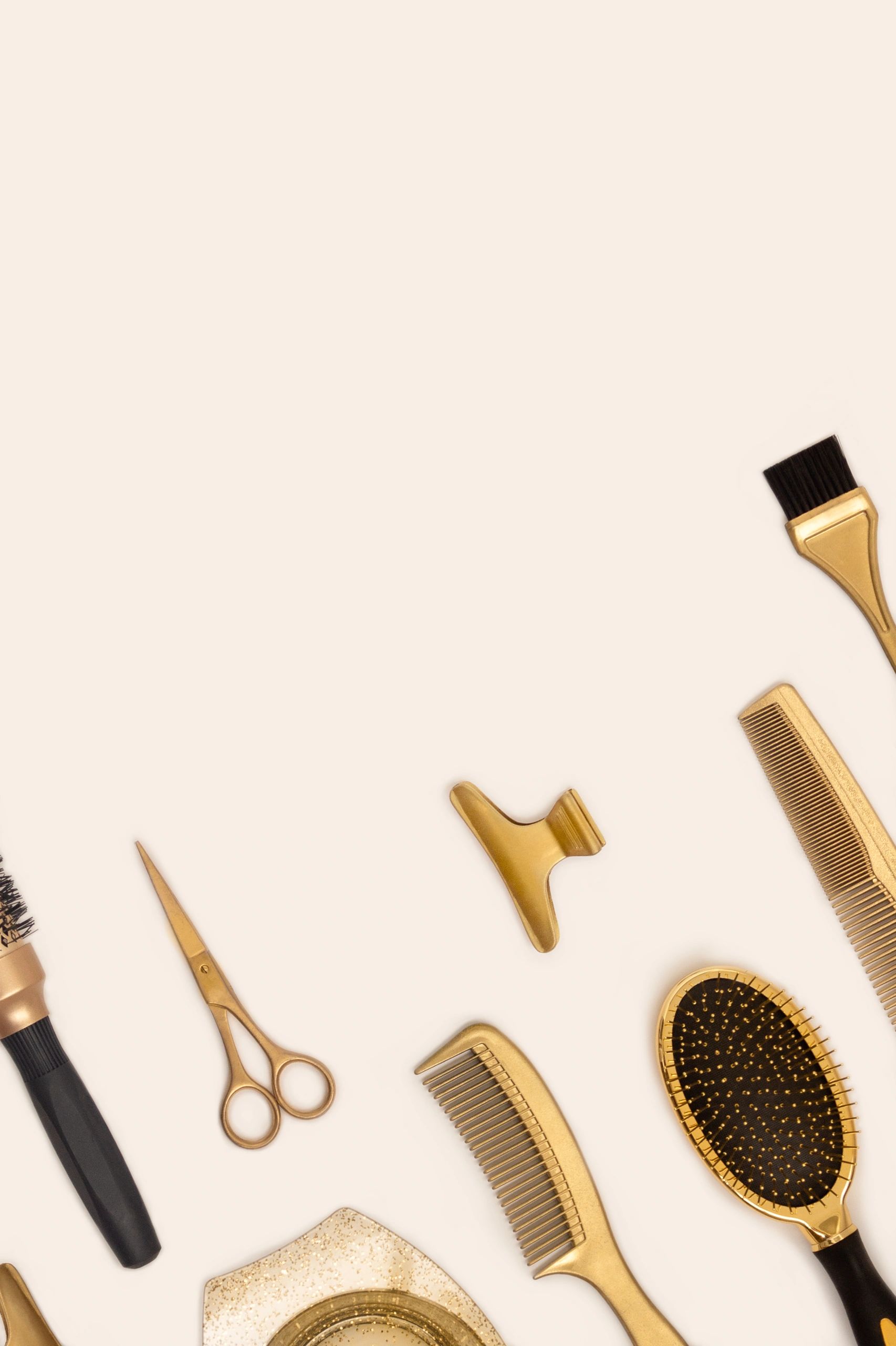 Hair styling tools and accessories arranged on a wooden surface.
