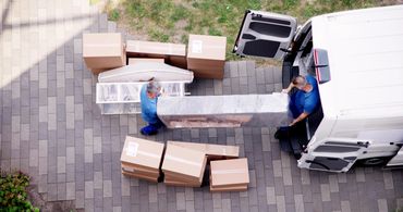 Professional movers loading furniture