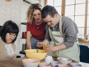 People preparing food together in a kitchen.