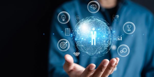 Person holding a digital network sphere with business icons floating around.