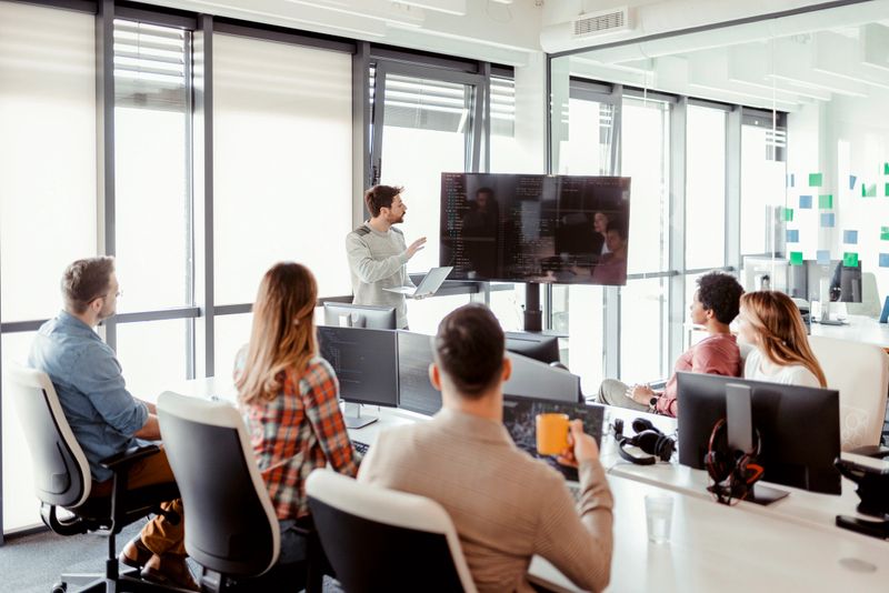It Business Startup Company Meeting. Team Leader Discussing and Brainstorming New Approaches and Ideas With Colleagues. Startup Business and Entrepreneurship Concept.