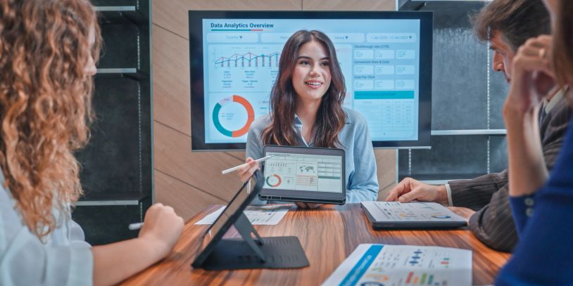 Analyzing financial data on a digital dashboard with a stylus.