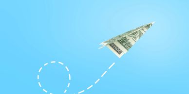 Paper airplane made of money flying upward