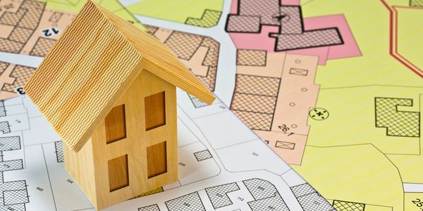 and image of a model home, sitting on property listings. 