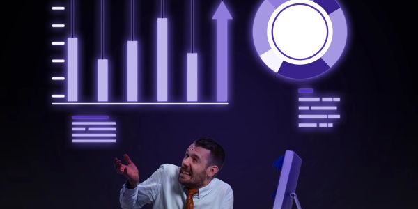 Man looking stressed with rising financial charts above him.