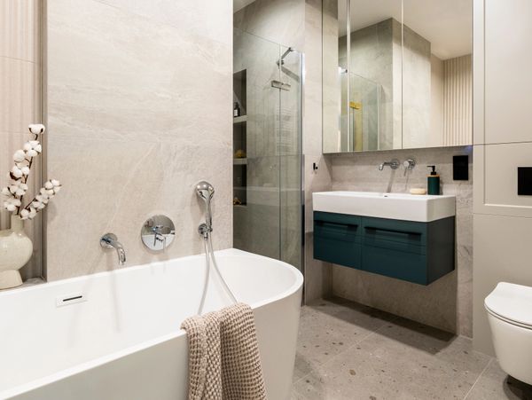 Modern bathroom with a sleek freestanding tub and floating vanity.