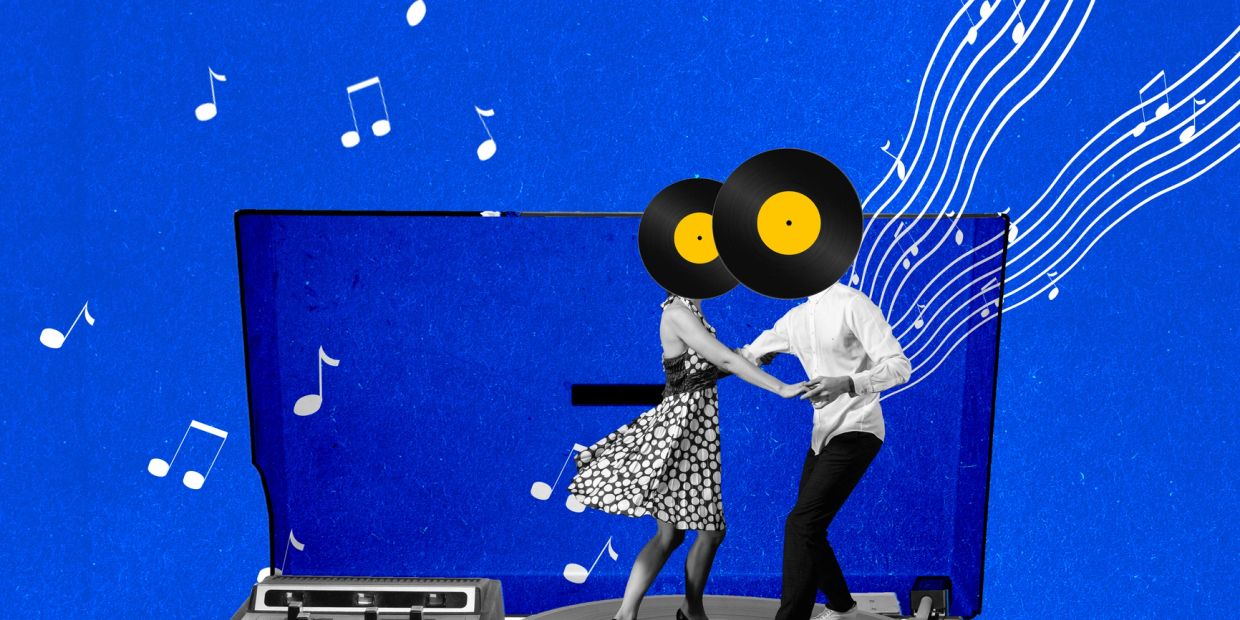 Dancing couple with vinyl record heads inside a record player against a blue musical background.