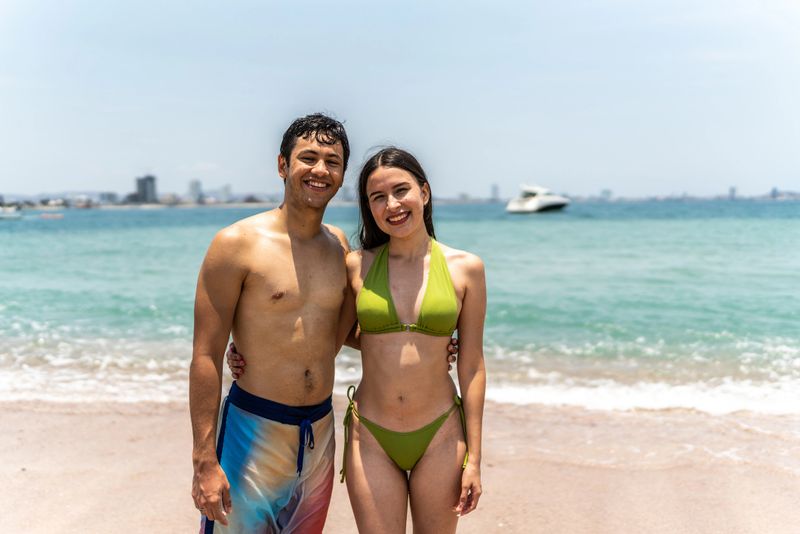 Portrait of young couple by the beach