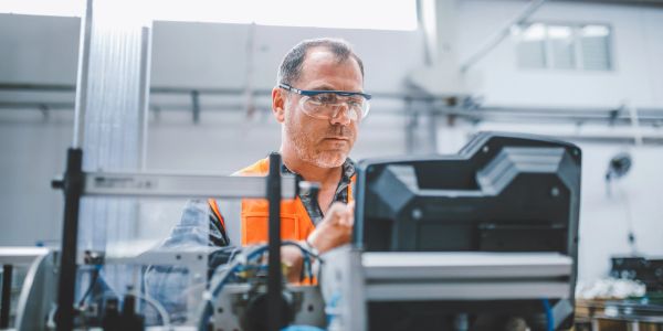 Engineer working with machinery in a factory.