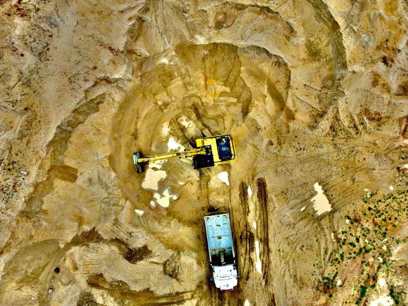 Excavator loading sand