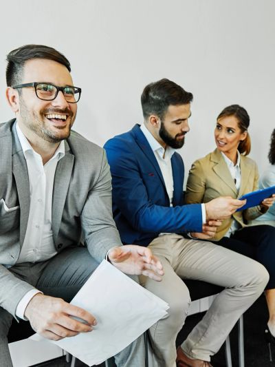 Professionals in business attire interacting during a meeting.