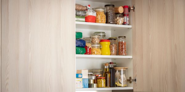 Cardboard box filled with assorted canned and bottled food items.