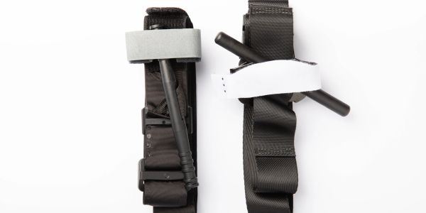 Two black tactical tourniquets with straps and windlasses on a white background.