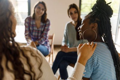 Women having a supportive group conversation.