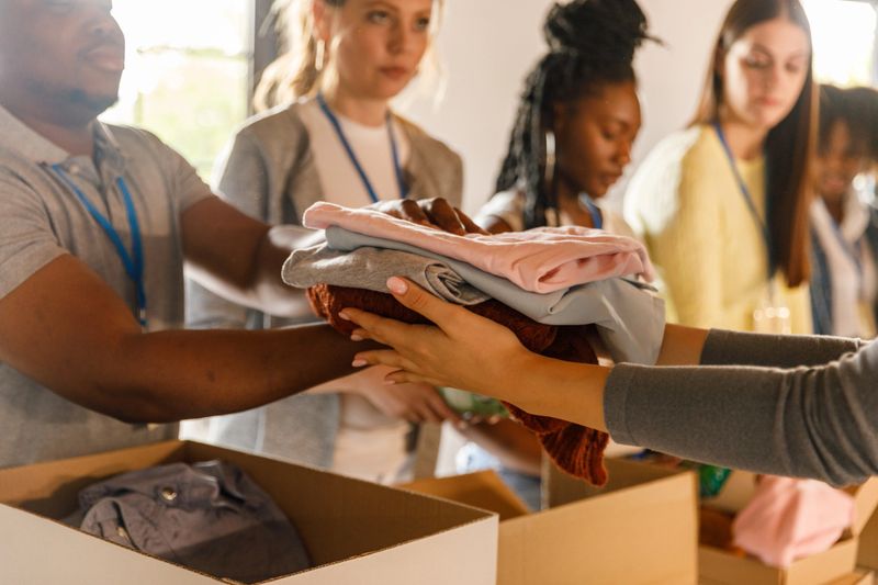 A team of selfless volunteers attentively organizes clothing donations, ensuring that each item is clean and ready to bring warmth to someone's life.