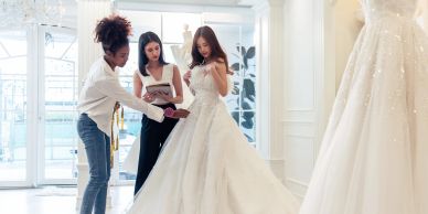 Bride trying on a wedding dress in a boutique.