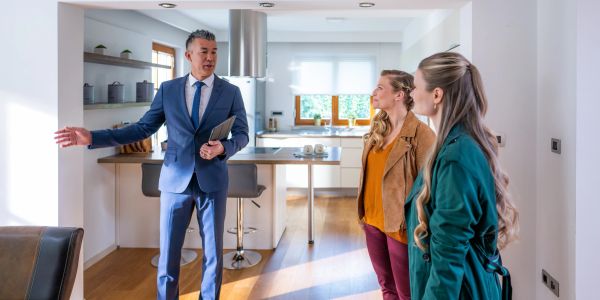 Real estate agent showing a house to two women.