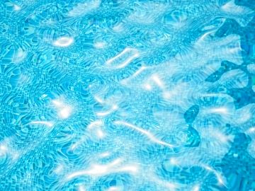 Sunlight reflecting on clear pool water.