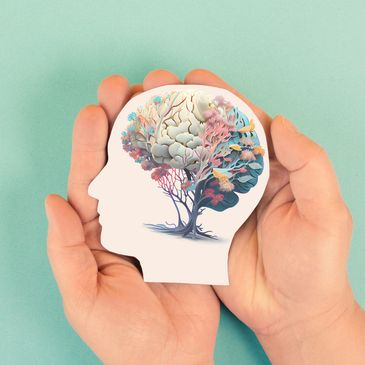 Human hands holding a brain tree silhouette.