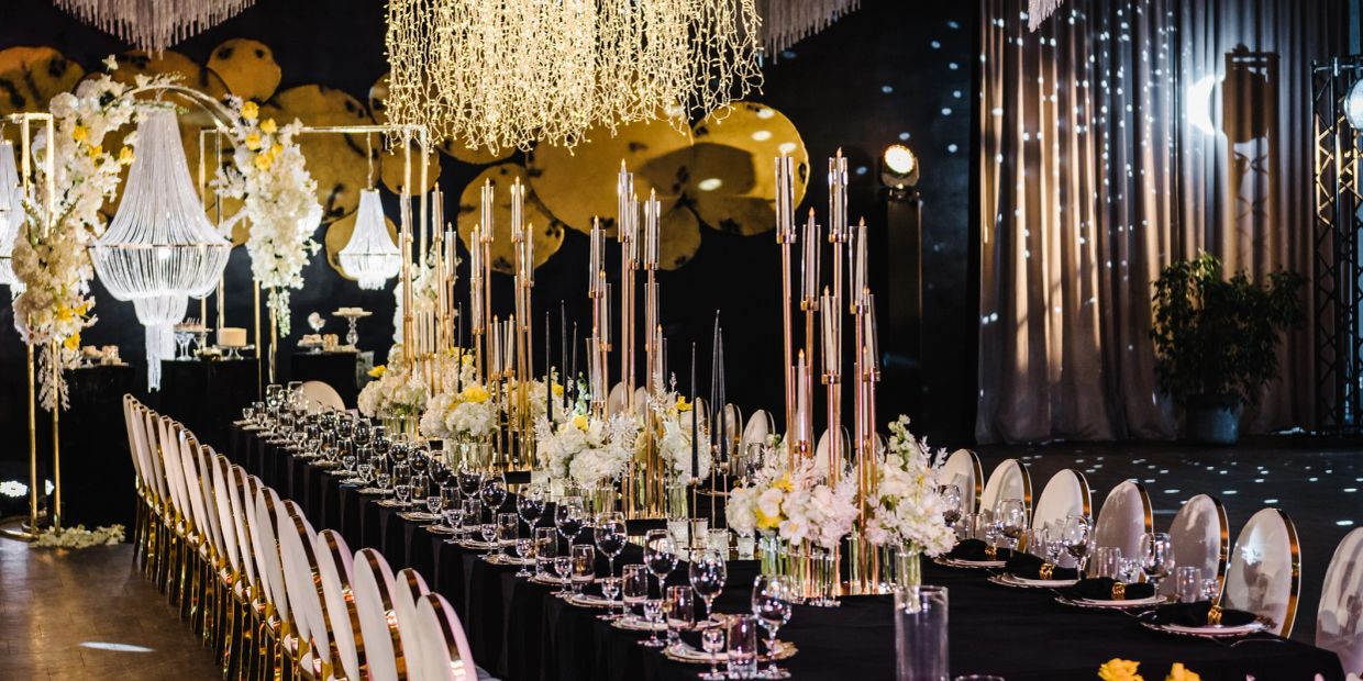 Luxurious banquet table set with elegant floral arrangements and candles.