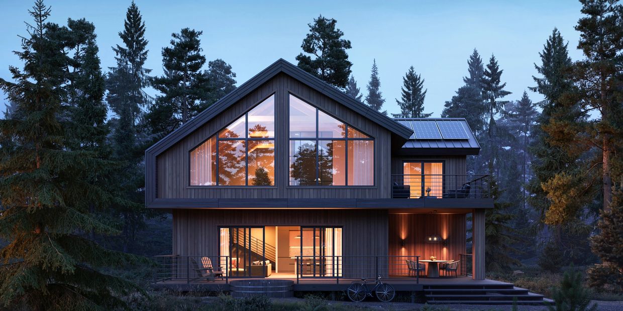 Modern wooden house with large windows and warm interior lighting in a forest setting at dusk.