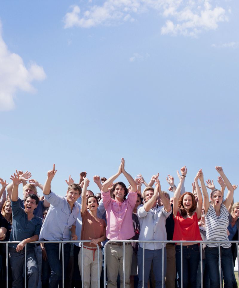 Cheering crowd with arms raised