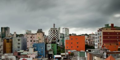 Colorful city buildings under a cloudy sky.