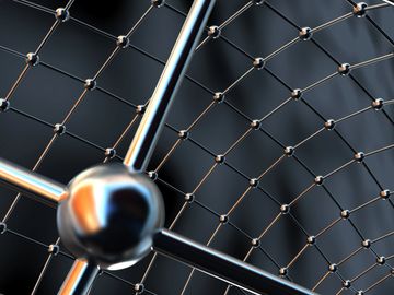 Close-up of a metallic molecular structure model with interconnected rods and spheres.
