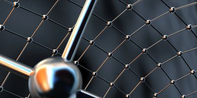 Close-up of a metallic molecular structure model with interconnected nodes.