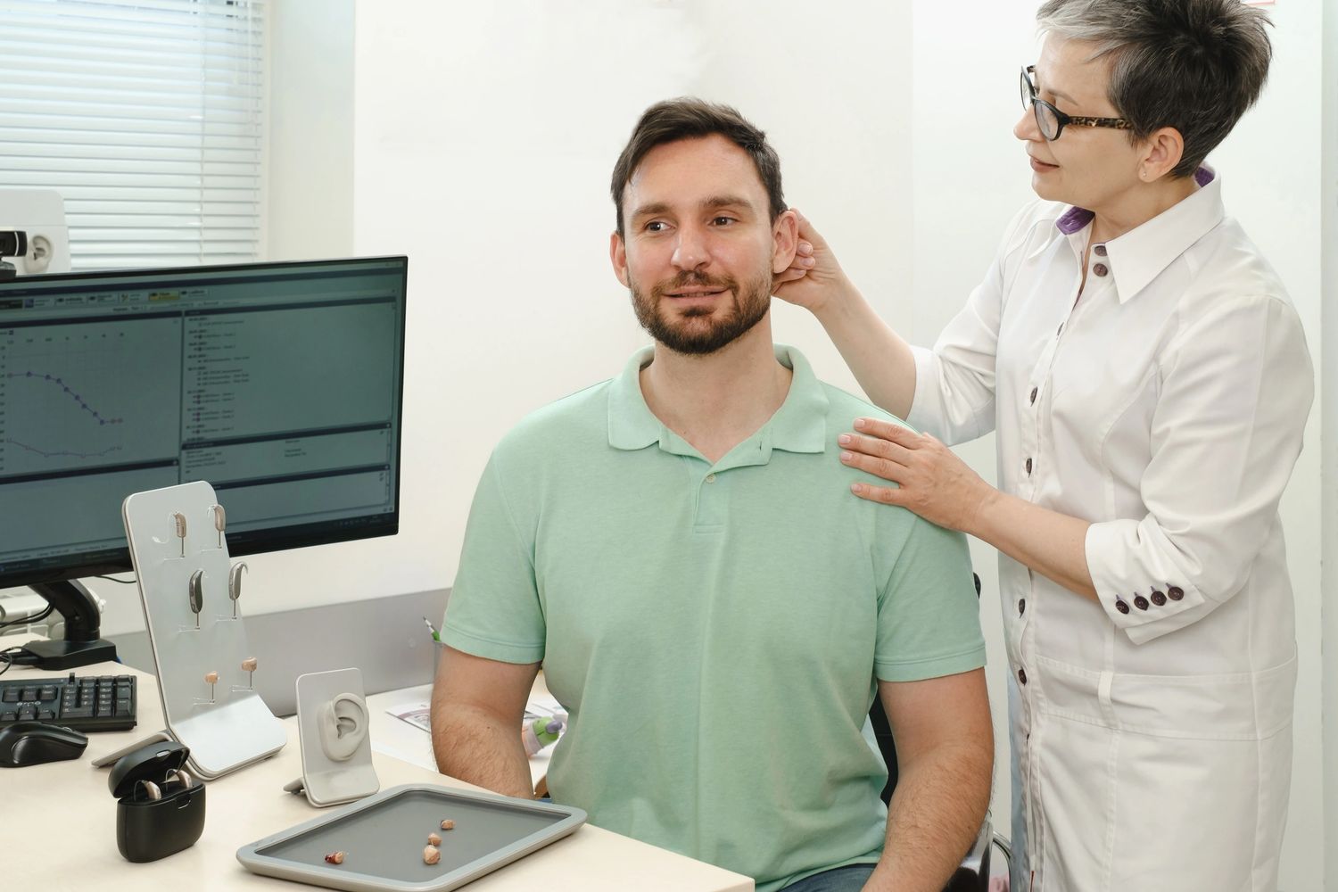 A doctor treating a mans ear
