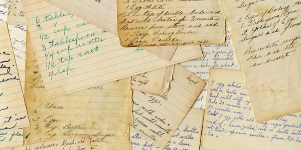 A collection of handwritten recipe cards with various notes and stains.