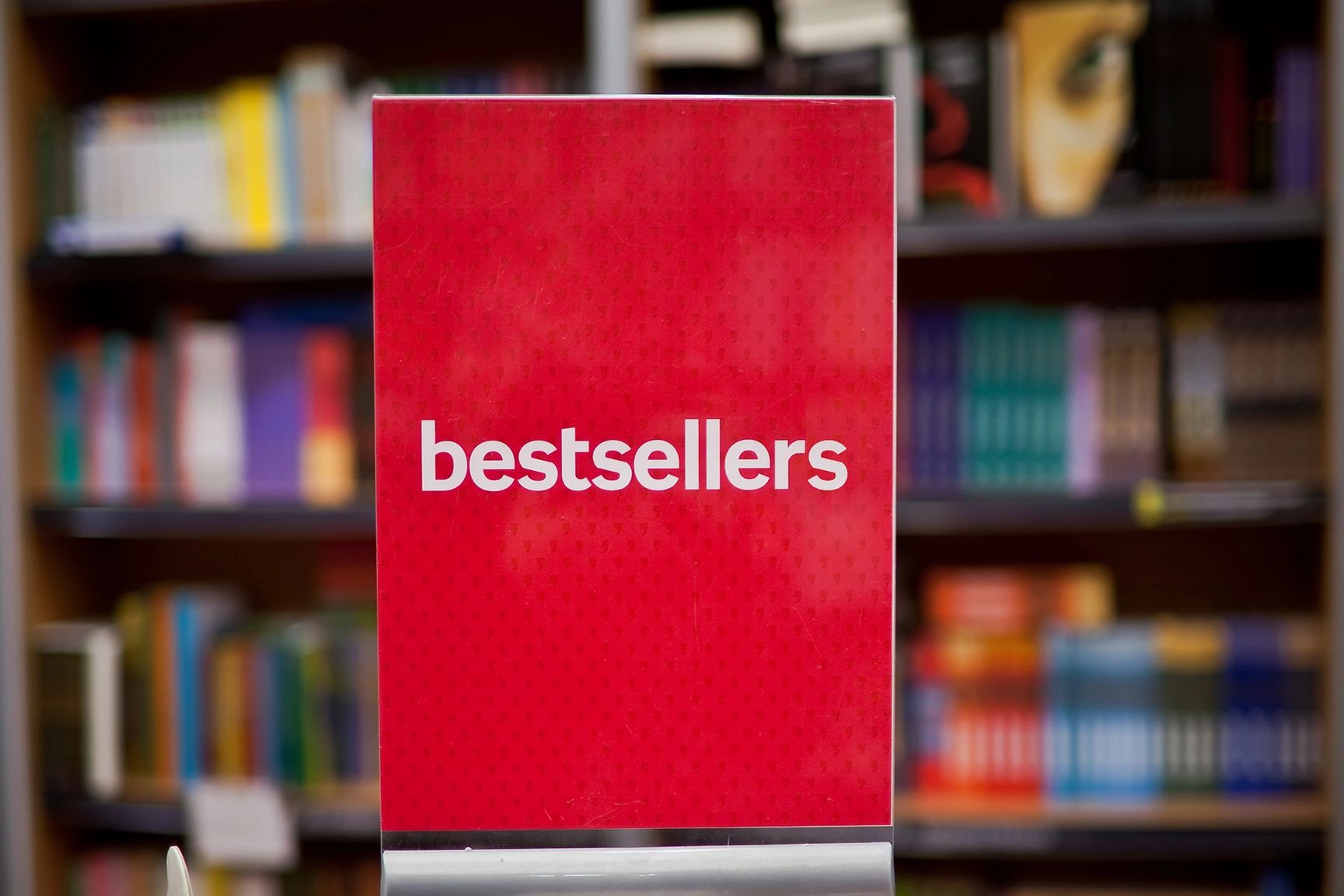 A sign that reads "bestsellers" is displayed in a book store