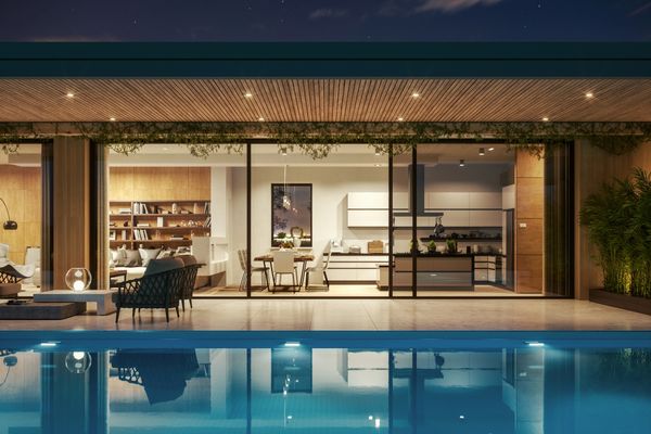 Modern house with pool, glass walls, and cozy indoor-outdoor living space at night.