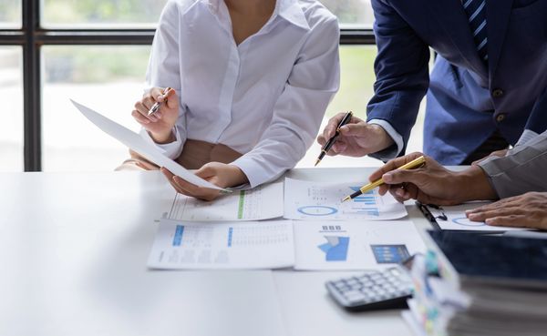 Image of workers looking at financial reports