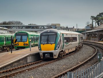 a class 700 train arrives in at a station.