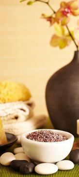 Amber essential oil bottles with fresh herbs and spices around.