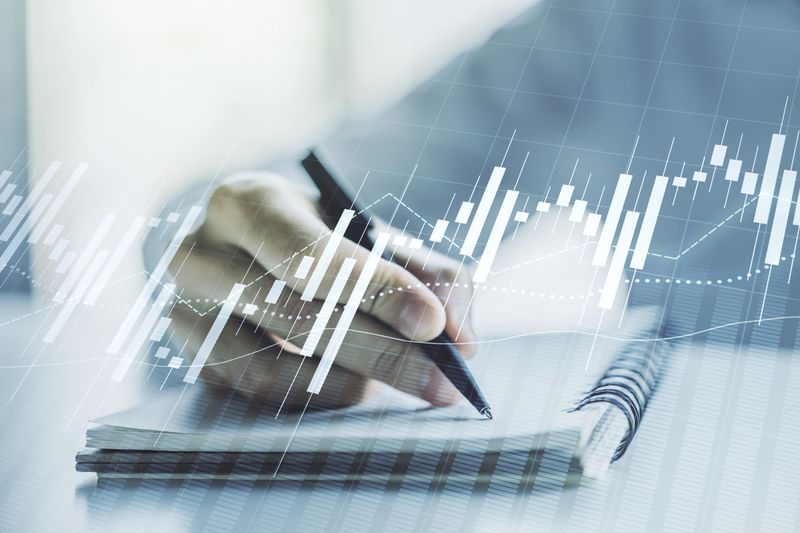 Multi exposure of abstract creative financial graph with hand writing in notepad on background, forex and investment concept