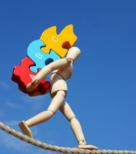 A group of people sitting at a table with papers and pens.